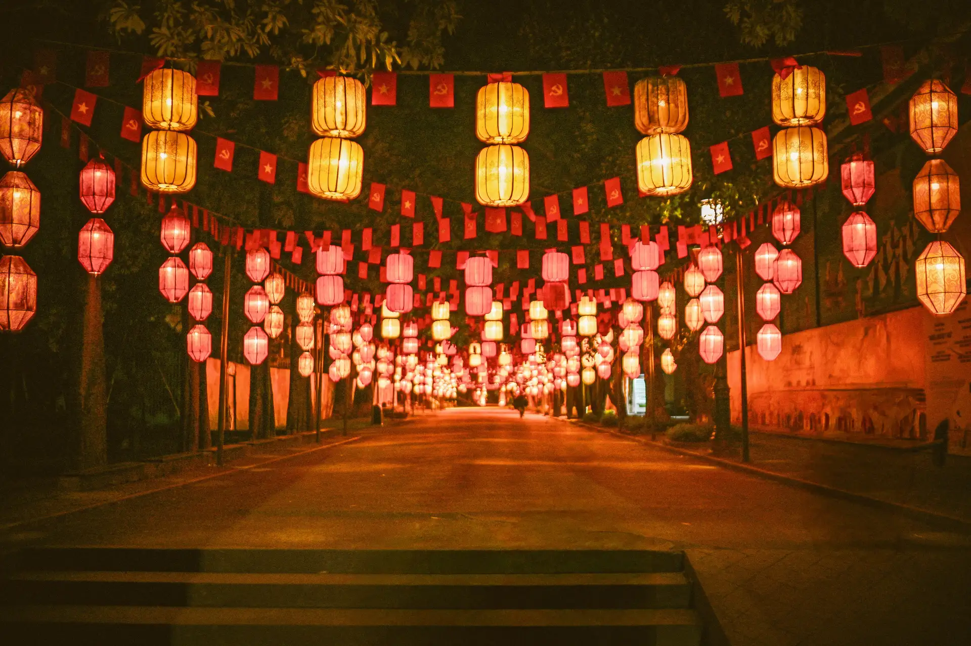 Red lanterns glowing above a street at night