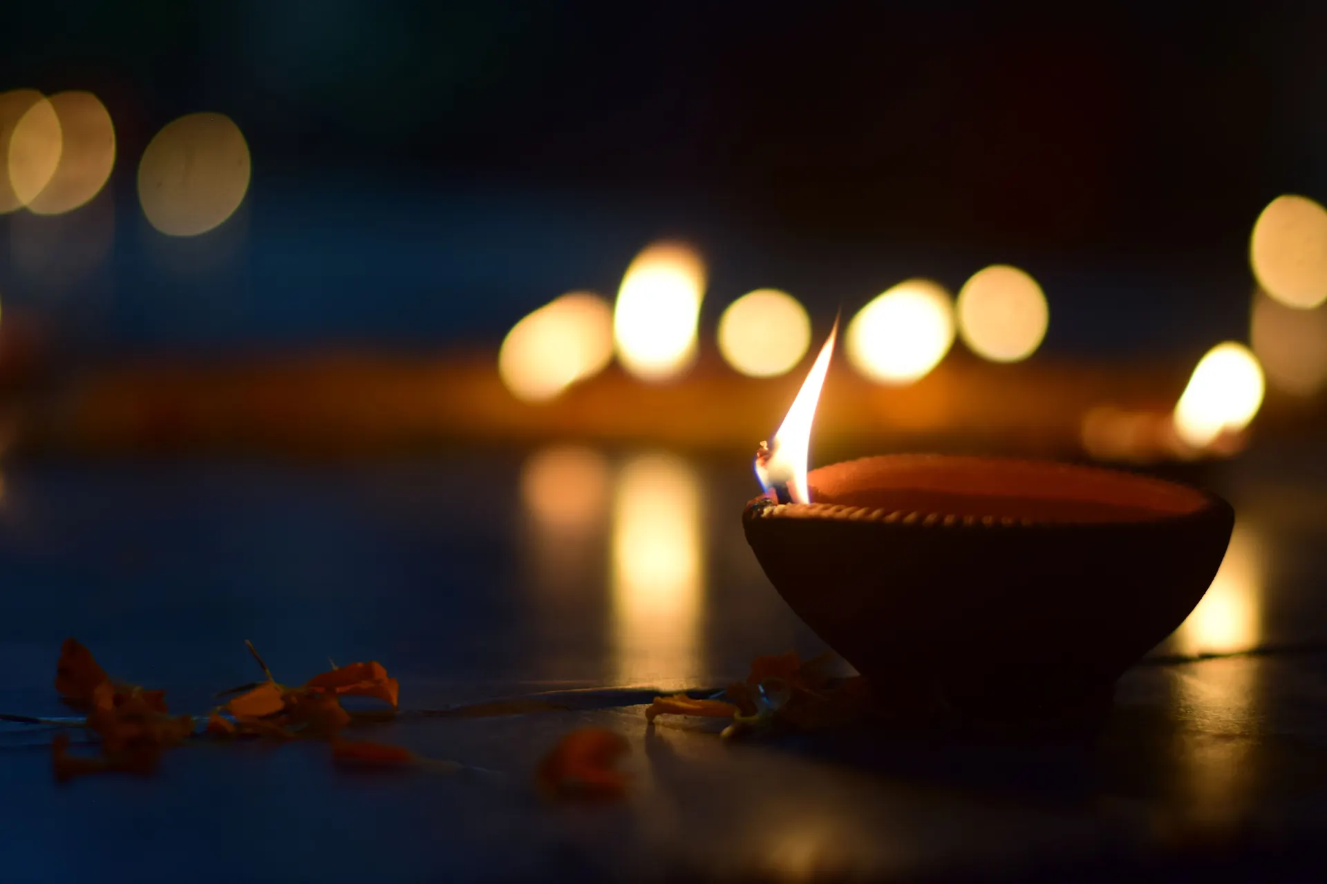 Lit diya lamps glowing at night