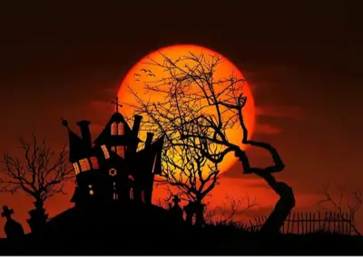 siloutee halloween scene with croocked house on a hill