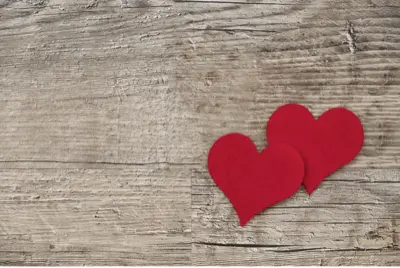 two hearts overlappingon a wooden desk